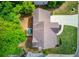 Aerial view of a well manicured yard with a patio, surrounded by green trees at 1099 Mount Water Ln, Lawrenceville, GA 30043