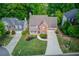 An aerial view of a brick front house with a well-kept lawn in a suburban neighborhood at 1099 Mount Water Ln, Lawrenceville, GA 30043