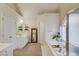 Bright bathroom with a soaking tub, separate shower, and double vanities at 1099 Mount Water Ln, Lawrenceville, GA 30043