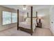 Bedroom with neutral walls, a four-poster bed, and large windows with natural light at 1099 Mount Water Ln, Lawrenceville, GA 30043