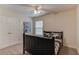 Bedroom featuring a ceiling fan, closet doors, and window for natural light at 1099 Mount Water Ln, Lawrenceville, GA 30043