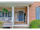 Inviting front entrance with a blue door, decorative wreath, and a cozy porch at 1099 Mount Water Ln, Lawrenceville, GA 30043