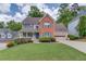 Charming two-story brick home with a well-manicured lawn and inviting front porch at 1099 Mount Water Ln, Lawrenceville, GA 30043