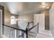 Upstairs hallway featuring neutral walls, modern lighting, and a charming window casting natural light at 1099 Mount Water Ln, Lawrenceville, GA 30043