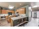 Open kitchen design with light wood cabinets, stainless steel appliances, and breakfast bar at 1099 Mount Water Ln, Lawrenceville, GA 30043
