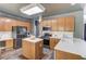 Kitchen with light wood cabinets, stainless appliances, kitchen island, and modern design at 1099 Mount Water Ln, Lawrenceville, GA 30043
