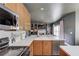 Spacious kitchen with oak cabinetry, stainless steel appliances, and an open layout to the living area at 1099 Mount Water Ln, Lawrenceville, GA 30043
