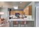 Bright kitchen with light wood cabinetry, modern appliances, and breakfast bar seating at 1099 Mount Water Ln, Lawrenceville, GA 30043