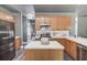 Well-lit kitchen features light wood cabinets, stainless steel appliances, and a functional island at 1099 Mount Water Ln, Lawrenceville, GA 30043