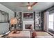 Cozy living room featuring a fireplace with built-in bookshelves and modern ceiling fan at 1099 Mount Water Ln, Lawrenceville, GA 30043