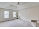 Spacious main bedroom with a tray ceiling, neutral walls, and plush carpeting at 1099 Mount Water Ln, Lawrenceville, GA 30043
