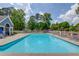 A large community pool surrounded by lounge chairs and lush trees, perfect for relaxation and recreation at 1099 Mount Water Ln, Lawrenceville, GA 30043