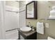 Bright bathroom features a shower-tub combo, stylish vanity with granite countertop, and a decorative mirror at 1868 Gordon Ne Mnr, Atlanta, GA 30307