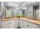 Well-lit bathroom featuring double sinks, white cabinetry and framed mirrors enhancing the bright space at 1868 Gordon Ne Mnr, Atlanta, GA 30307