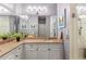 Well-lit bathroom with double sinks, white cabinets, and a glass-enclosed shower for a modern look at 1868 Gordon Ne Mnr, Atlanta, GA 30307