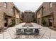 Stunning courtyard with brick buildings, a central fountain, and a large stone table for outdoor gatherings at 1868 Gordon Ne Mnr, Atlanta, GA 30307