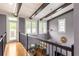Upstairs hallway with natural light, wood floors, and elegant railings overlooking the downstairs dining area at 1868 Gordon Ne Mnr, Atlanta, GA 30307