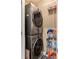 Efficient laundry room with stacked washer and dryer, and shelving for organized storage of laundry supplies at 1868 Gordon Ne Mnr, Atlanta, GA 30307