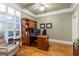 Well-lit home office with hardwood floors, built-in shelving, and a comfortable workspace for productivity at 1868 Gordon Ne Mnr, Atlanta, GA 30307