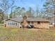 Brick house with a grill in the backyard, complemented by lush green grass and a charming setting at 2588 Shady Sw Ln, Conyers, GA 30094