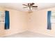 A bedroom featuring two windows with blue curtains and a ceiling fan with lights at 2588 Shady Sw Ln, Conyers, GA 30094
