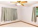 Neutral bedroom with ceiling fan, carpet flooring, and window with exterior view at 2588 Shady Sw Ln, Conyers, GA 30094