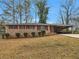 Charming brick ranch home with a covered carport and neatly manicured shrubbery at 2588 Shady Sw Ln, Conyers, GA 30094