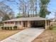 Charming brick home featuring a covered carport and a long concrete driveway at 2588 Shady Sw Ln, Conyers, GA 30094