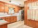 Functional kitchen with stainless steel appliances, wood cabinets, and vinyl flooring at 2588 Shady Sw Ln, Conyers, GA 30094