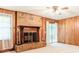 Inviting living room featuring brick fireplace and hardwood paneling at 2588 Shady Sw Ln, Conyers, GA 30094
