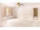 Bright living room featuring neutral carpeting, a ceiling fan, and window drapes at 2588 Shady Sw Ln, Conyers, GA 30094