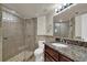 Bathroom featuring tiled glass shower, granite counters, and tile floors at 795 Hammond Dr # 808, Atlanta, GA 30328