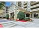Inviting building entrance with covered parking, mature landscaping, and an easy path to the front doors at 795 Hammond Dr # 808, Atlanta, GA 30328