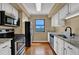 Updated kitchen features granite countertops, stainless steel appliances, and modern white cabinetry at 795 Hammond Dr # 808, Atlanta, GA 30328