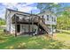 Exterior view of the home showcasing the elevated deck and landscaped backyard at 2120 Pair Sw Rd, Marietta, GA 30008