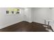 Finished basement with a window, dark wood floors, and white bar stools at 2120 Pair Sw Rd, Marietta, GA 30008