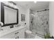 Modern bathroom features a marble-tiled shower with glass door, vanity with mirror, and stylish fixtures at 2120 Pair Sw Rd, Marietta, GA 30008