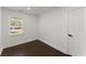 Bedroom features a window with blinds, white walls, dark wood floors, and a white door at 2120 Pair Sw Rd, Marietta, GA 30008