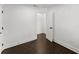 A simple, clean bedroom with dark wood flooring, white walls, and white trim at 2120 Pair Sw Rd, Marietta, GA 30008