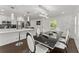 Open concept dining area with modern black table, bright lighting, and stylish decor at 2120 Pair Sw Rd, Marietta, GA 30008