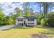 Inviting two-story home boasts a lush green lawn and a timeless painted brick exterior at 2120 Pair Sw Rd, Marietta, GA 30008
