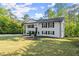 Charming two-story home with a manicured front yard and a long driveway at 2120 Pair Sw Rd, Marietta, GA 30008