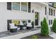 Charming front porch with elegant seating, manicured shrubs, and a welcoming front door at 2120 Pair Sw Rd, Marietta, GA 30008