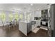 Bright kitchen with white cabinets, stainless steel appliances, and a dining area with natural light at 2120 Pair Sw Rd, Marietta, GA 30008