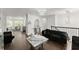 Spacious living area with hardwood floors, modern chandeliers, and elegant furnishings at 2120 Pair Sw Rd, Marietta, GA 30008