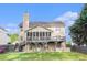 Two story home boasts a covered back patio and fenced backyard, complete with lush landscaping at 2164 Caneridge Sw Dr, Marietta, GA 30064