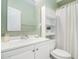 Well-lit bathroom featuring white vanity and shower with curtains at 2164 Caneridge Sw Dr, Marietta, GA 30064