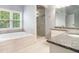 Bright bathroom featuring double vanity with granite countertop, tub and shower with glass doors at 2164 Caneridge Sw Dr, Marietta, GA 30064