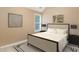 Calm bedroom features neutral paint, a queen bed, bedside tables, and carpet at 2164 Caneridge Sw Dr, Marietta, GA 30064