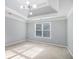 Spacious bedroom with a tray ceiling, modern light fixture and a large window with lots of natural light at 2164 Caneridge Sw Dr, Marietta, GA 30064
